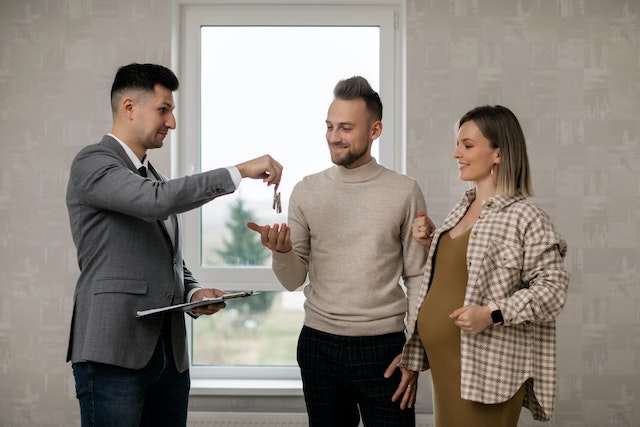 Landlord%20handing%20keys%20to%20a%20young%20couple Landlord%20handing%20keys%20to%20a%20young%20couple
